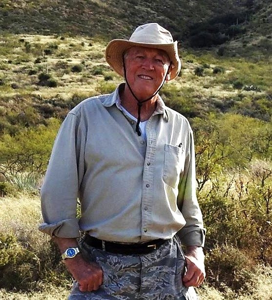Ed Breeding standing in the desert hills
